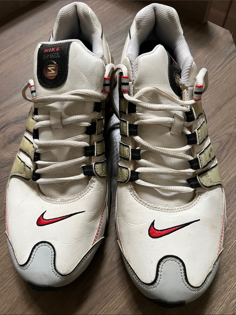Nike Men’s White Athletic Shoes with Red Swoosh and Gold Side Accents